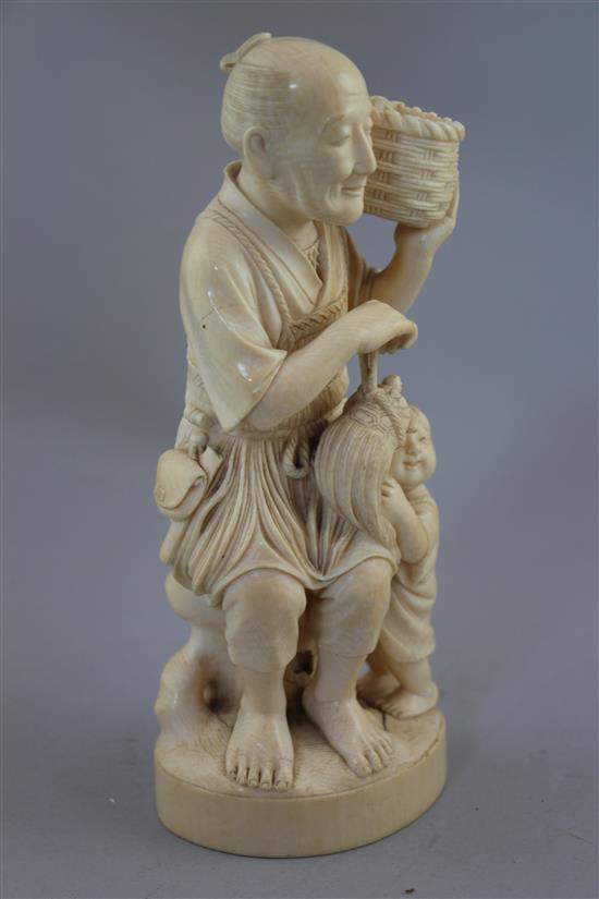 A Japanese ivory group of a fisherman and a boy, early 20th century, 13.5cm, age cracks